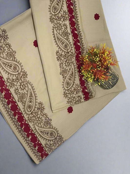 Beige fabric with red and gold paisley patterns on a gray background