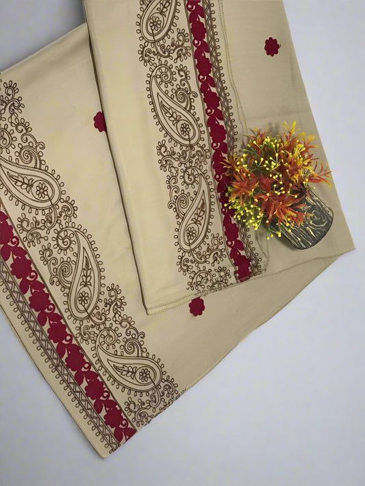 Beige fabric with red and gold paisley patterns on a white background