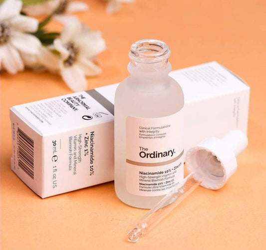 The Ordinary skincare serum bottle with dropper on an orange background