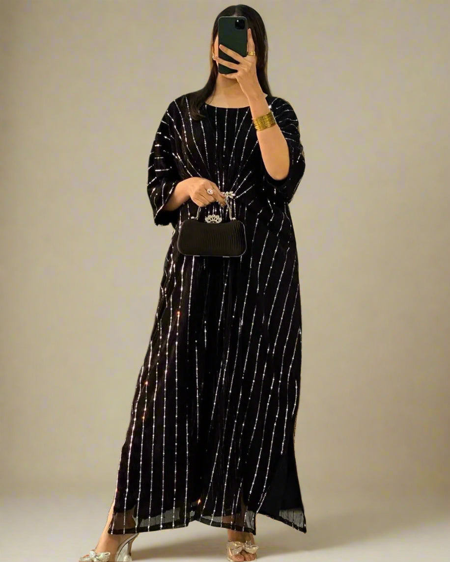 Person wearing a black and white striped dress