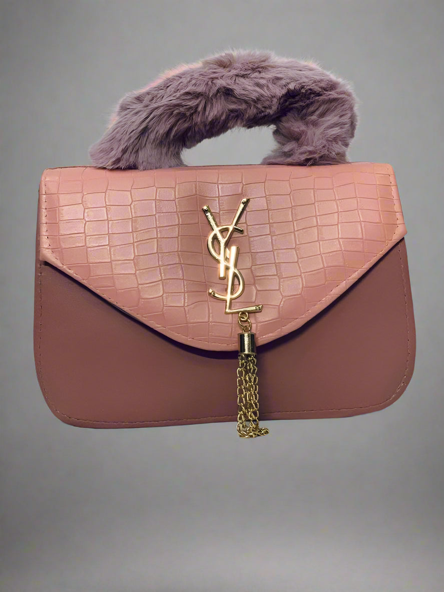 Pink handbag with fur handle on a light gray background.