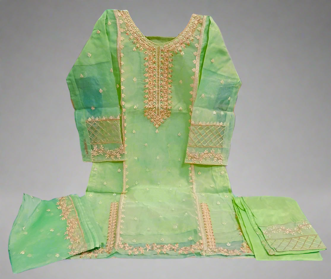 Green embroidered traditional outfit on a gray background