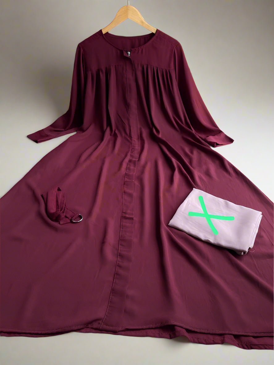 Maroon dress with a pocket featuring a green 'X' on a plain background