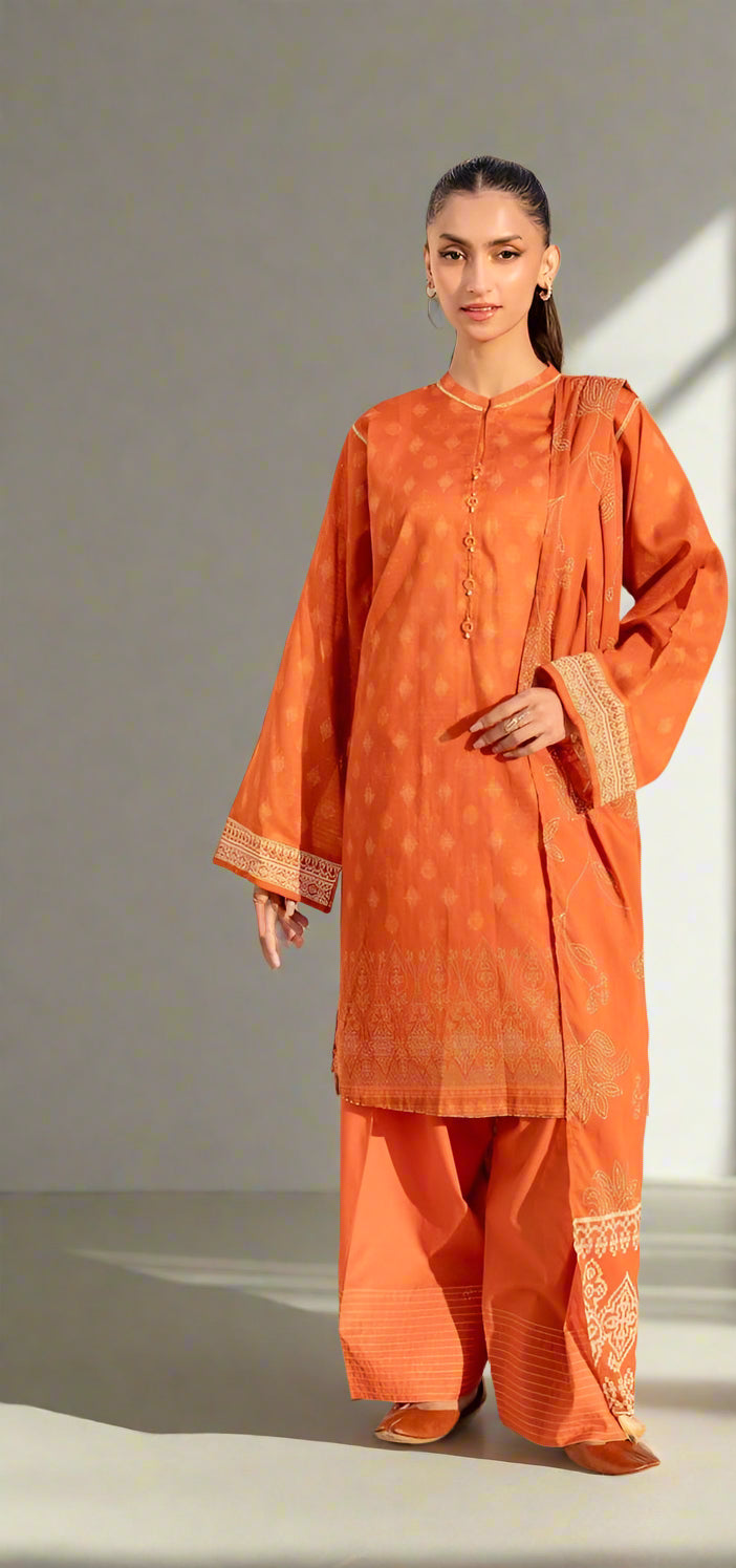 Woman wearing an orange traditional outfit with intricate patterns on a plain background