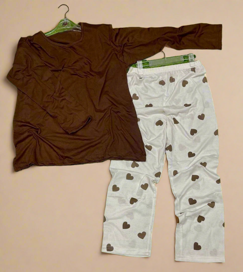 Brown shirt and white pants with heart patterns on a beige background