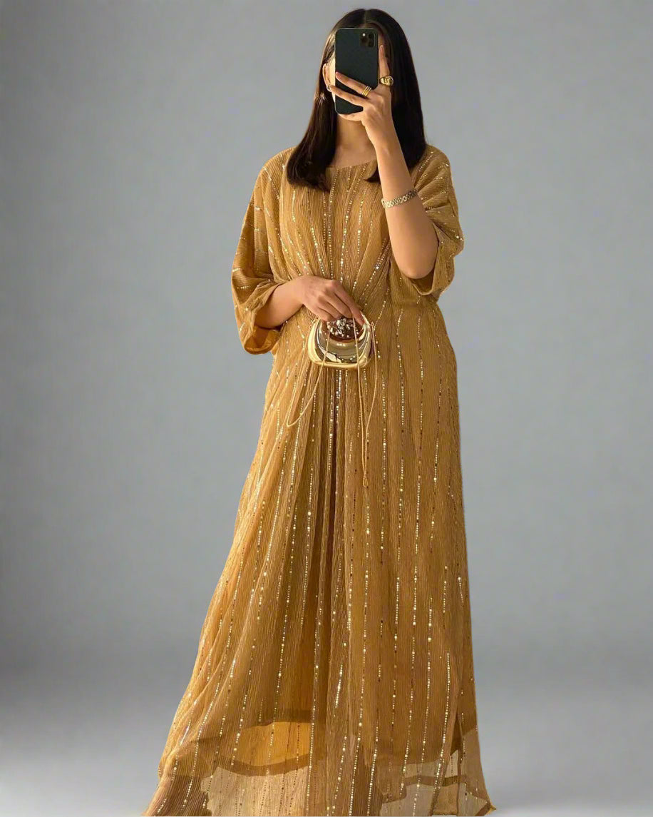 Person wearing a mustard yellow dress with a pattern