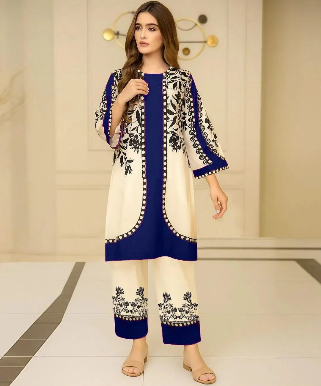 Woman wearing a blue and white embroidered outfit in an indoor setting