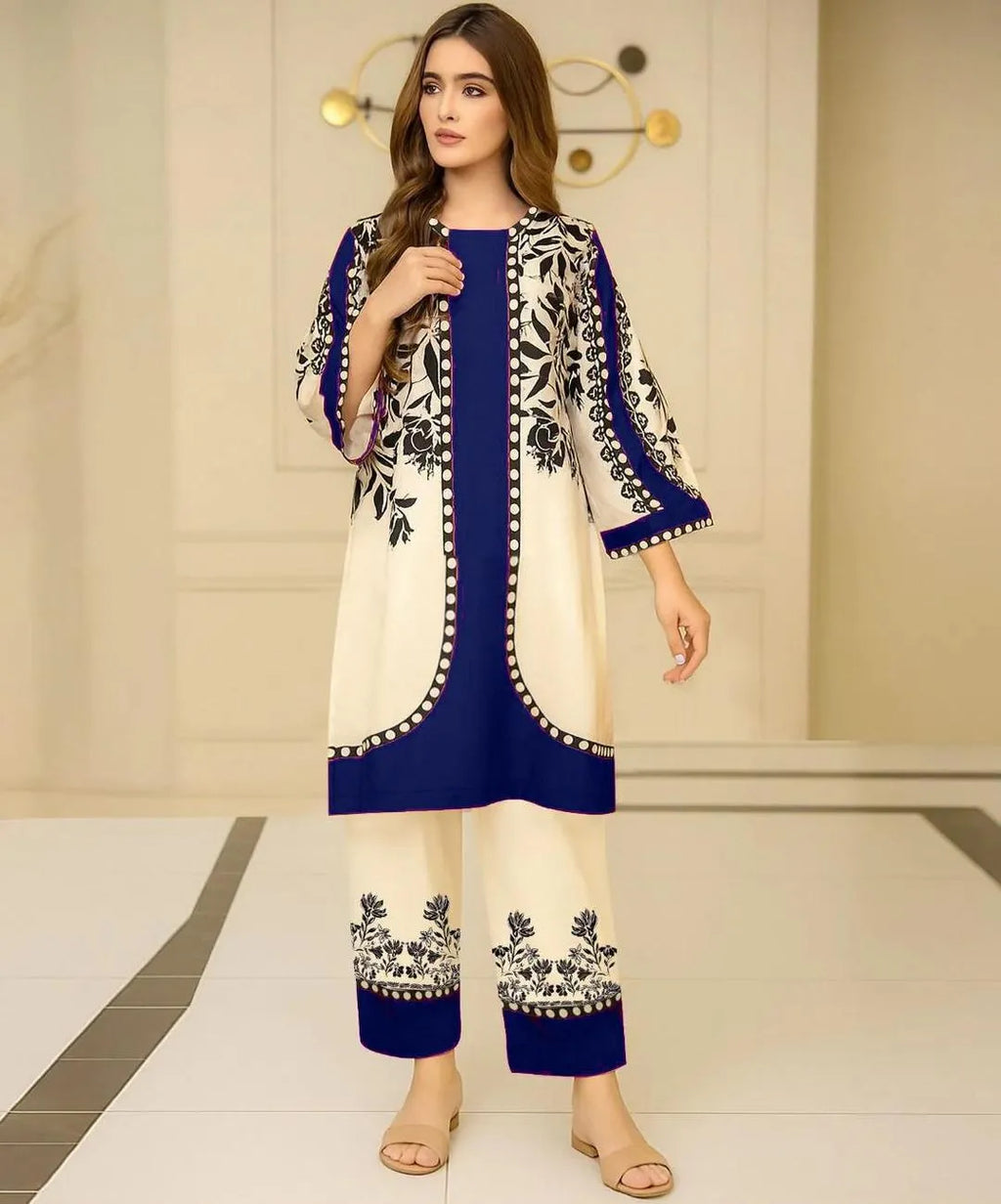 Woman wearing a blue and white embroidered outfit in an indoor setting