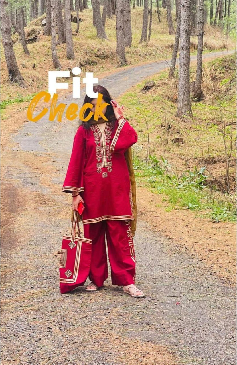 Person in a red traditional outfit standing on a forest path with 'Fit Check' text overlay.