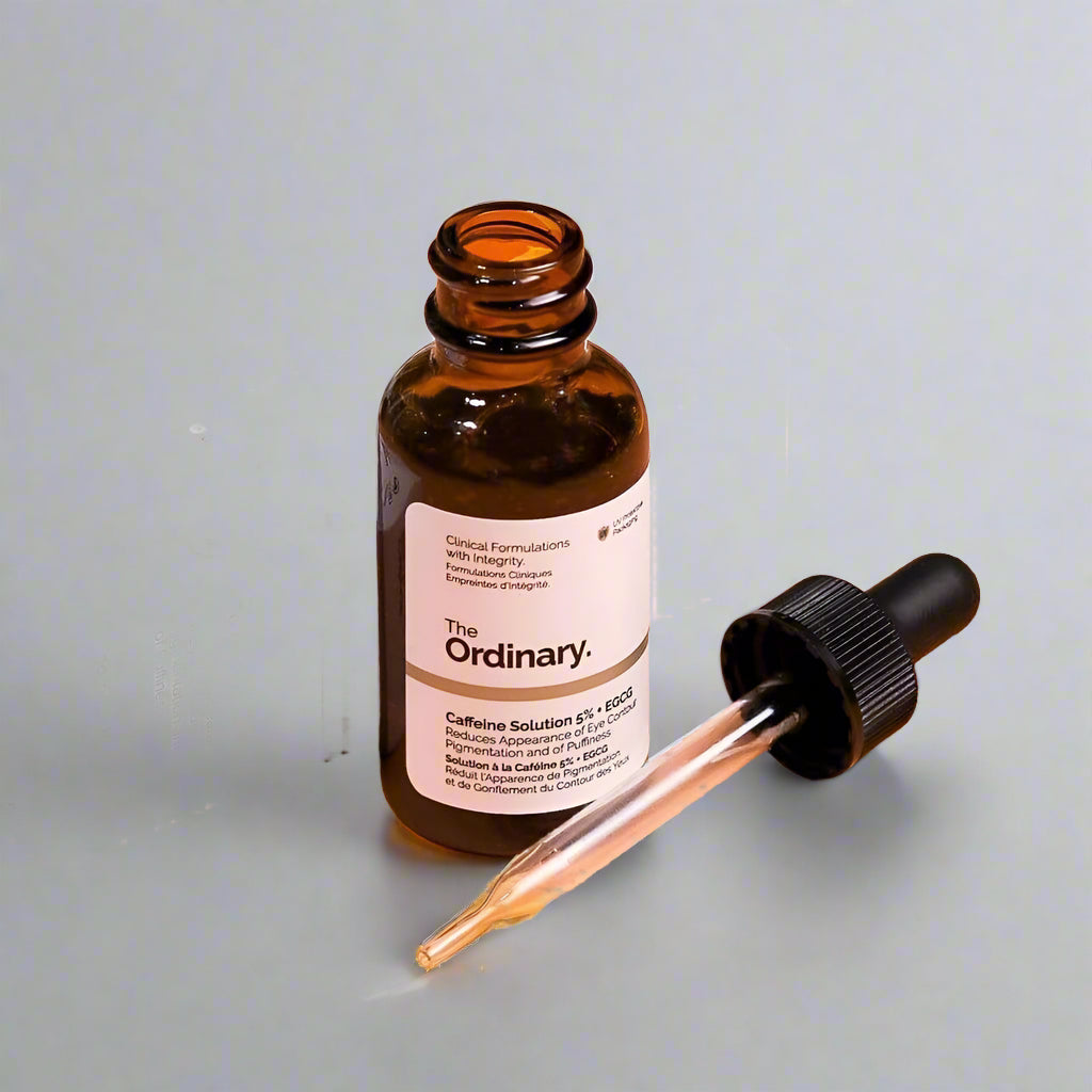 The Ordinary skincare product with dropper on an orange background