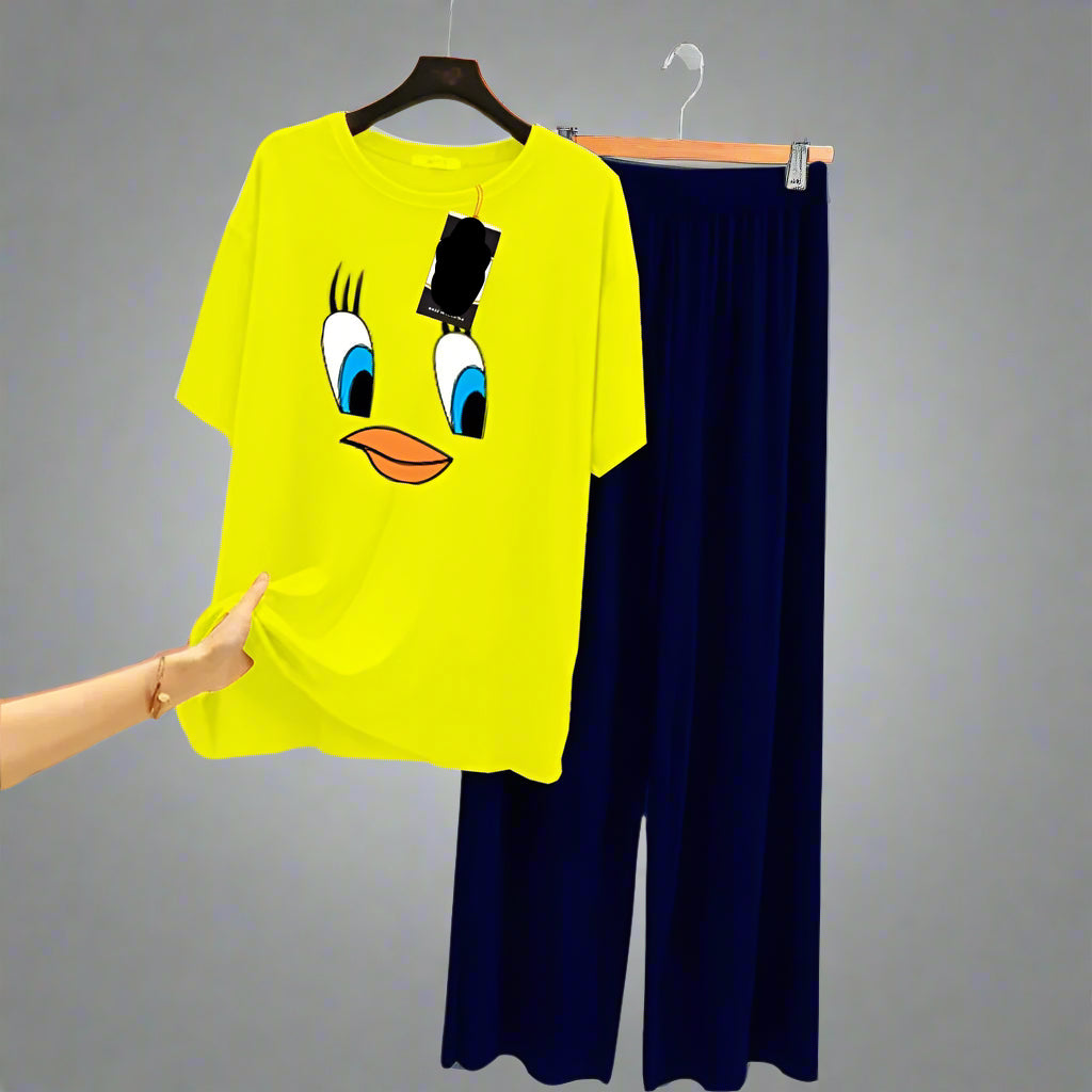 Yellow t-shirt with cartoon face design and navy pants on a gray background