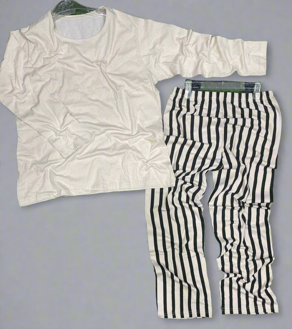White shirt and black and white striped pants on a gray surface